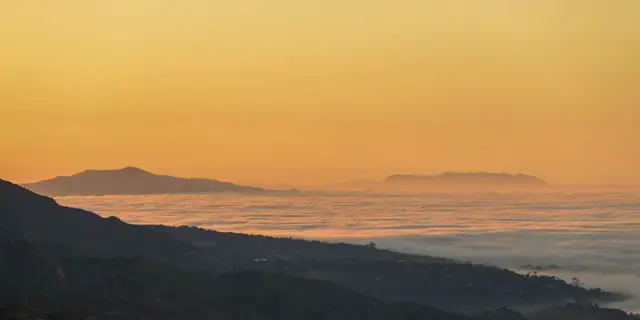 Fog settling over coastal hills and the sea near Santa Barbara at sunrise
